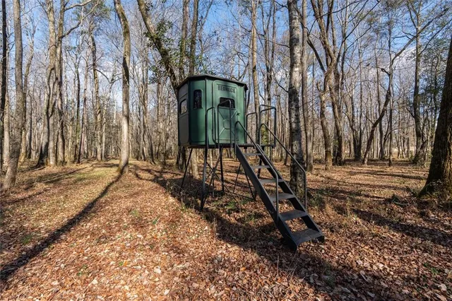 a backyard of a house with barbeque oven table and chairs