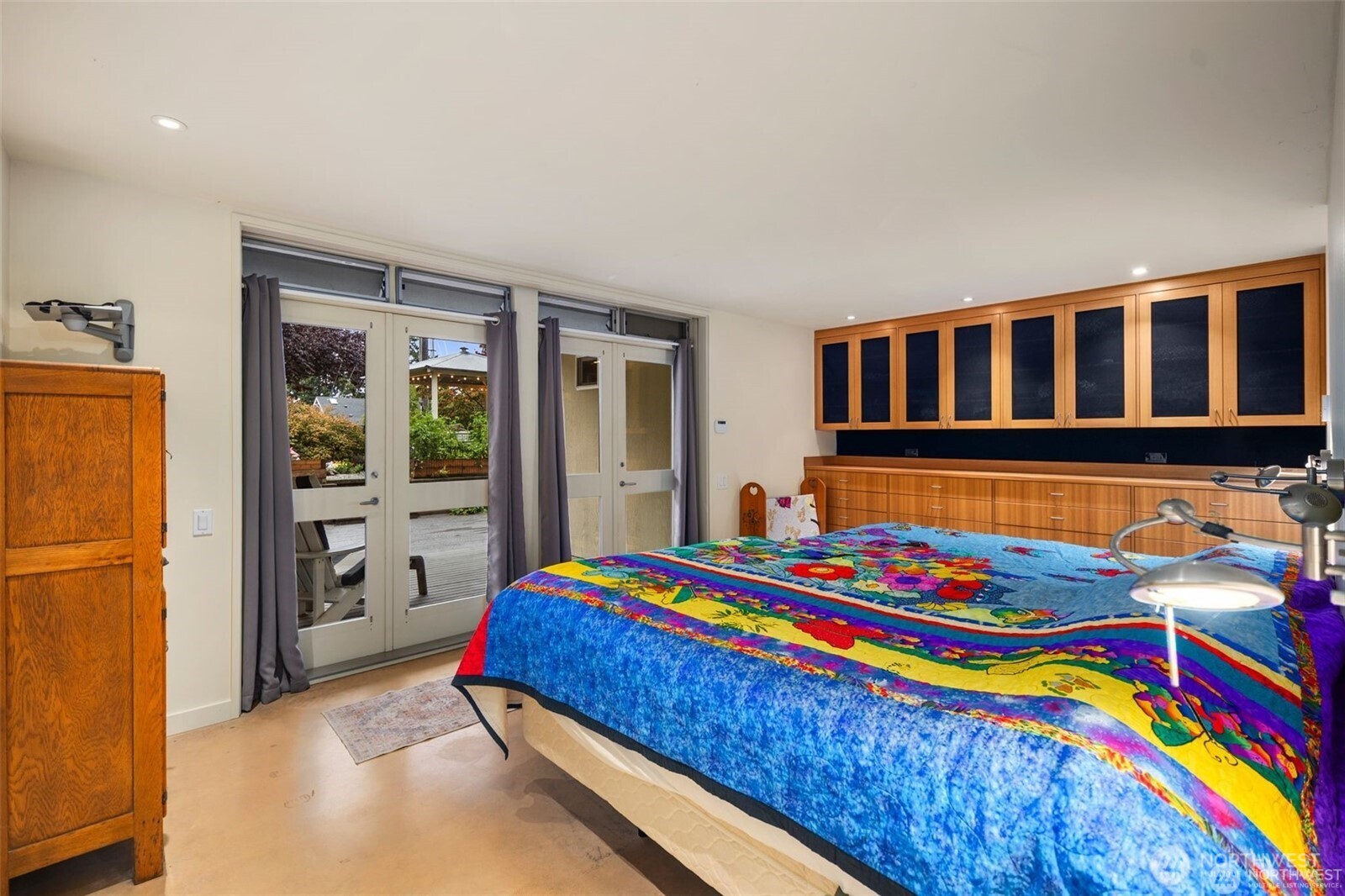 4712 Southwest Brace Point Drive Seattle, WA 98136 - Photo 30 of 40 a bedroom with a bed and a dresser with wooden floor