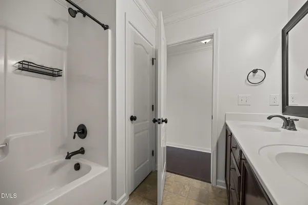 a bathroom with a double vanity sink and a mirror