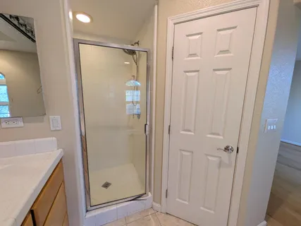 a bathroom with a shower and a sink