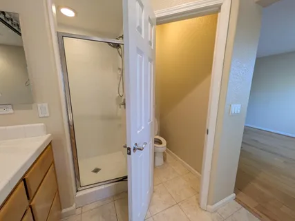 a bathroom with a granite countertop shower and a sink