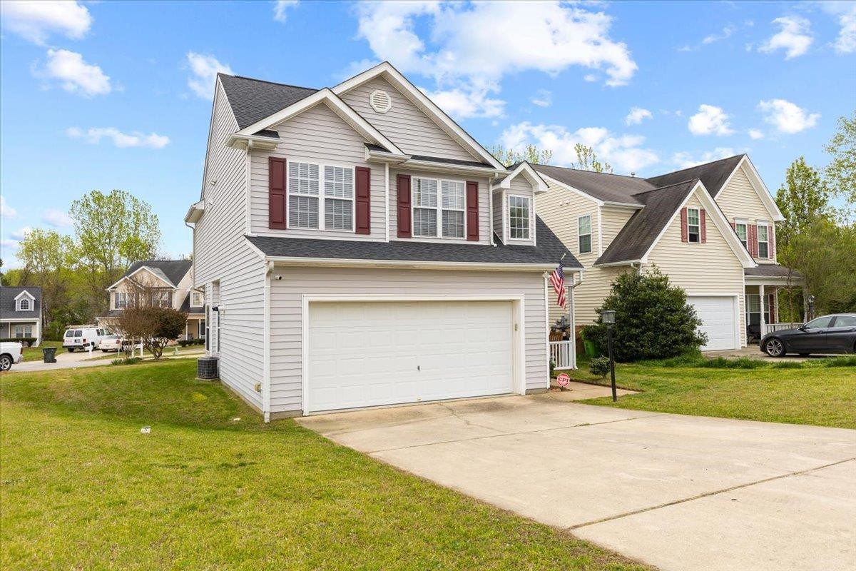 2025 Cartier Ruby Lane Raleigh, NC 27610 - Photo 3 of 37 a front view of a house with a yard and garage