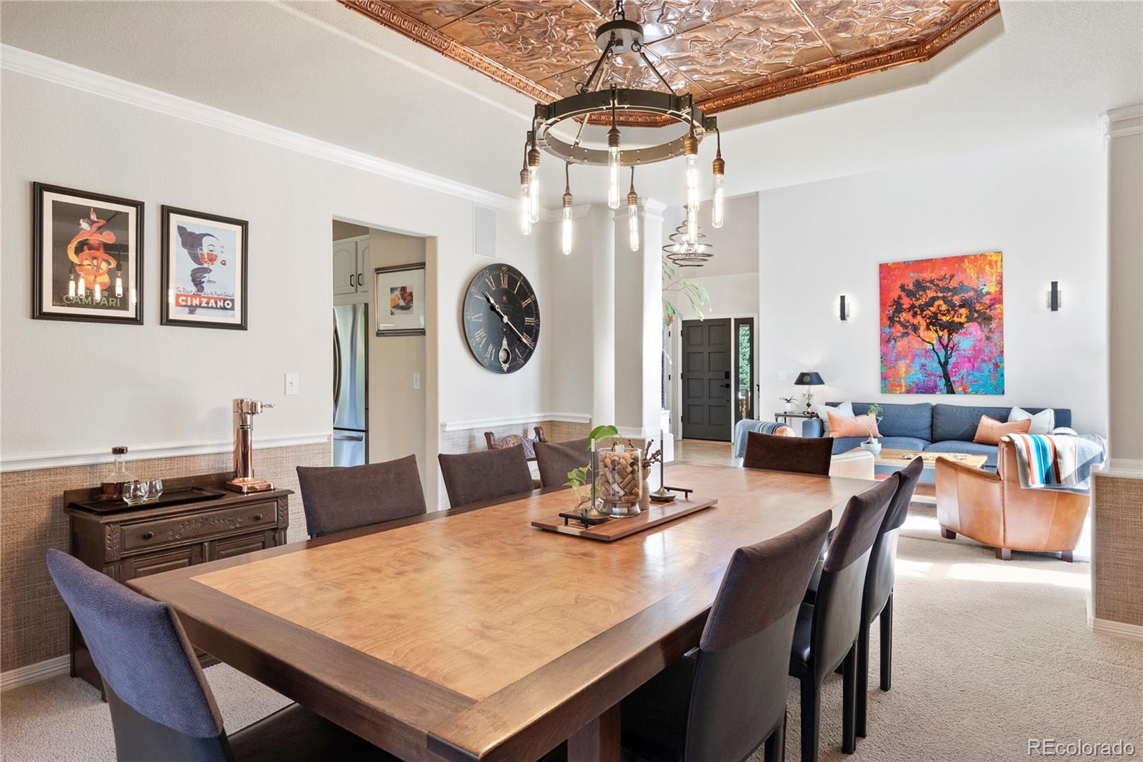 3822 Broadmoor Loop Broomfield, CO 80023 - Photo 16 of 50 a view of a dining room and livingroom with furniture wooden floor and a chandelier