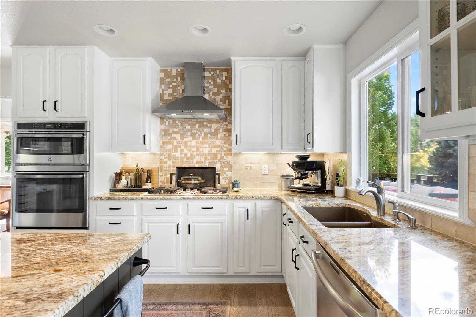 3822 Broadmoor Loop Broomfield, CO 80023 - Photo 22 of 50 a kitchen with granite countertop a sink stove and refrigerator