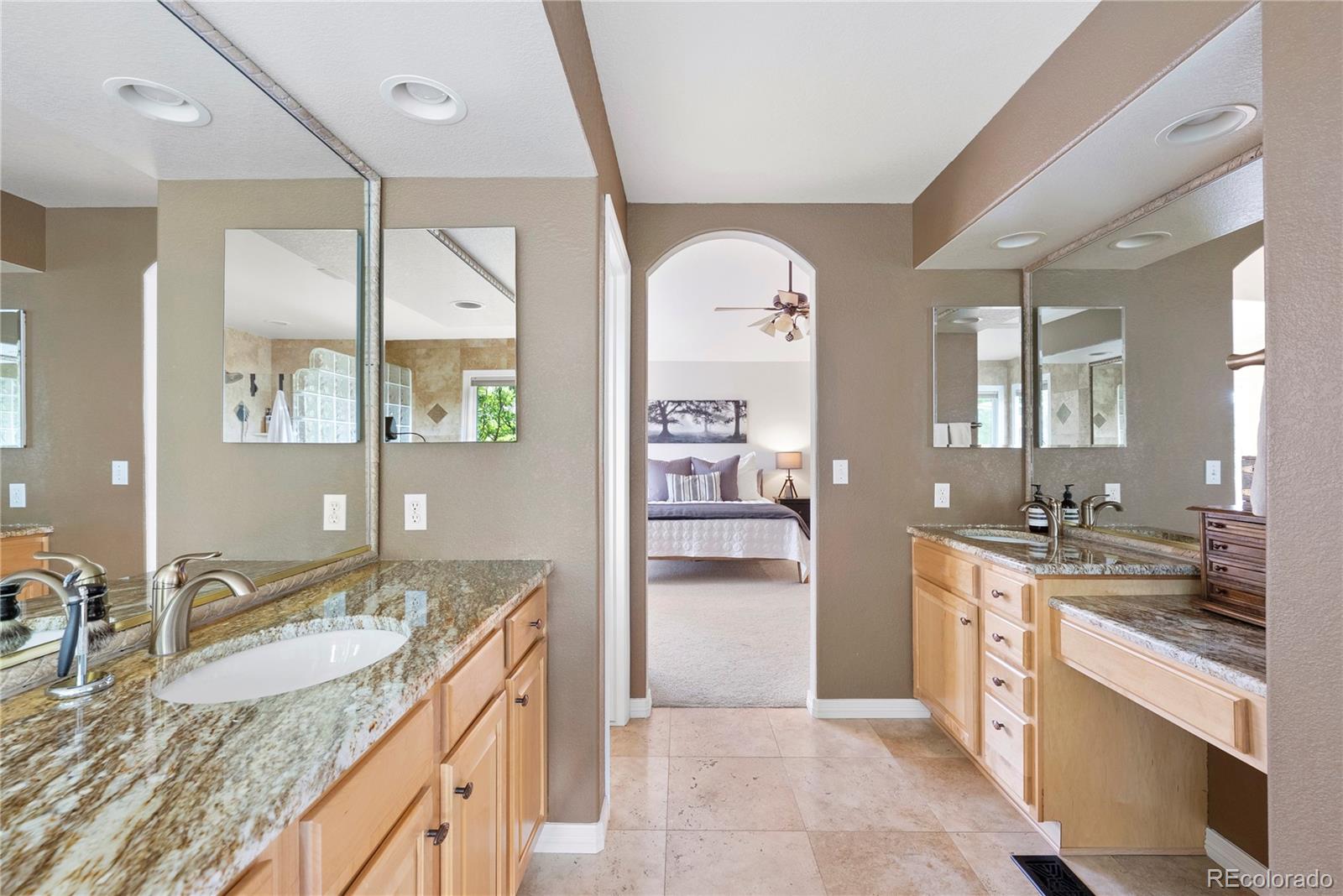 3822 Broadmoor Loop Broomfield, CO 80023 - Photo 31 of 50 a large bathroom with a granite countertop double vanity sink and a mirror