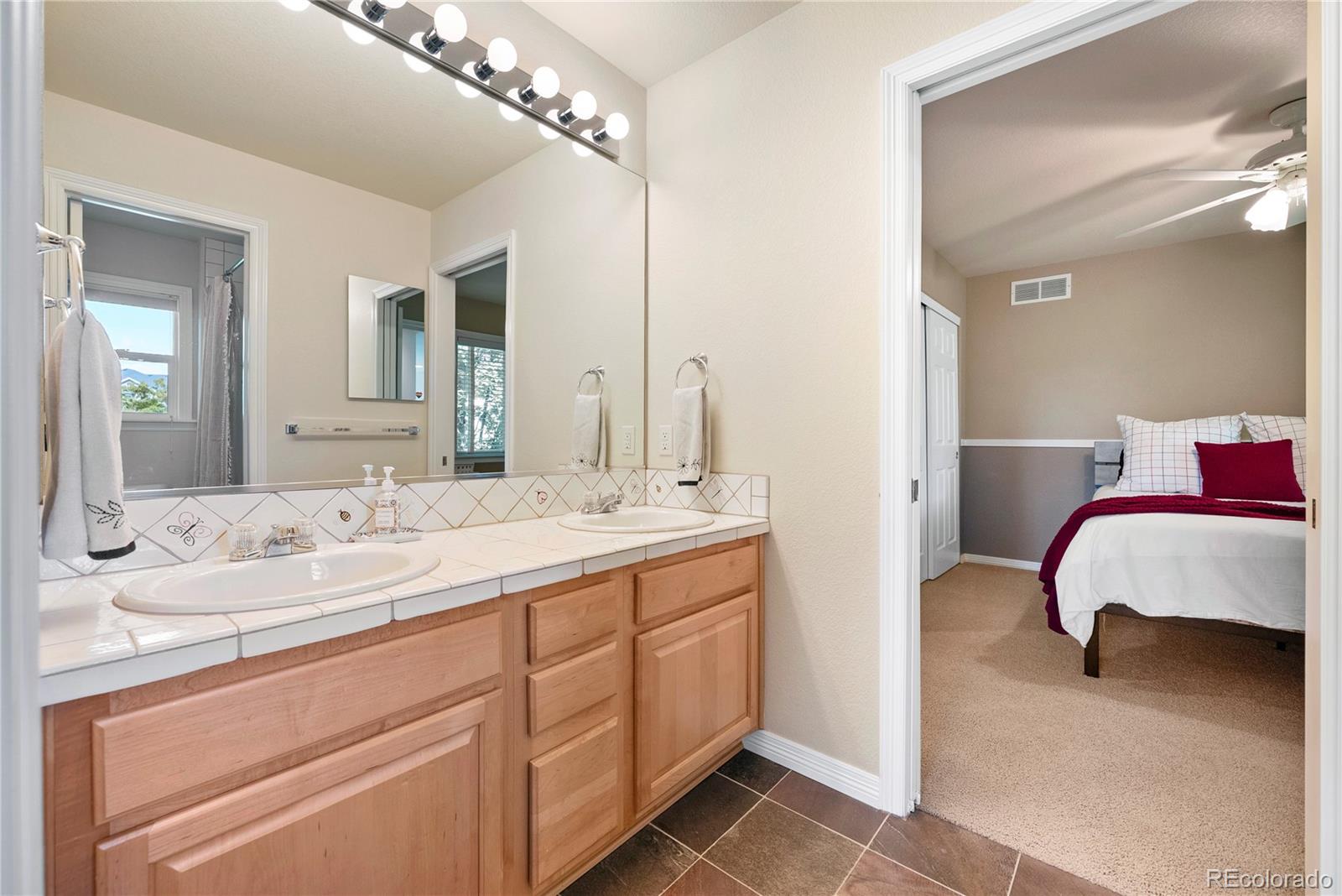 3822 Broadmoor Loop Broomfield, CO 80023 - Photo 36 of 50 a en suite bathroom with a double vanity sink and a mirror