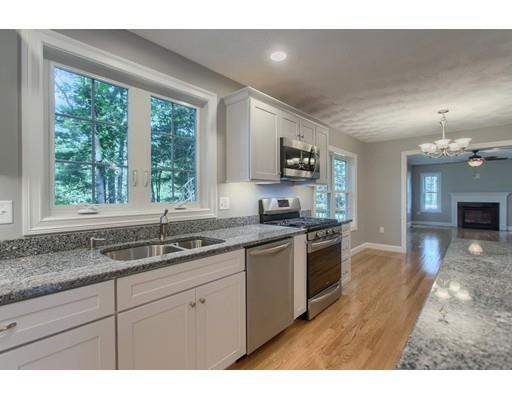 80 Whipple Road Billerica, MA 01821 - Photo 6 of 19 a kitchen with stainless steel appliances granite countertop a sink a stove top oven a counter space and cabinets