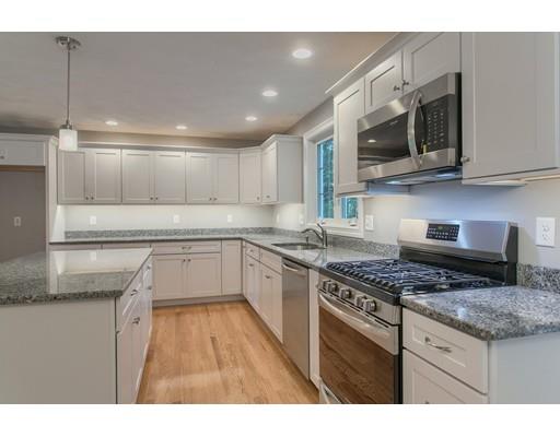 80 Whipple Road Billerica, MA 01821 - Photo 7 of 19 a kitchen with stainless steel appliances granite countertop a sink and a stove