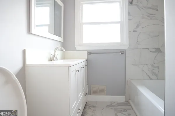 a bathroom with a sink a bathtub and a shower