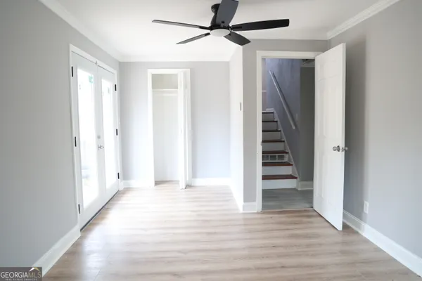 a view of a hallway with wooden floor and entryway