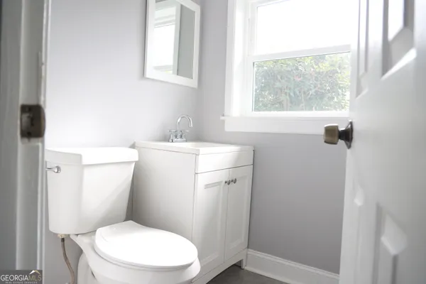 a white toilet sitting next to a bathroom sink
