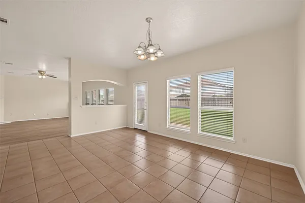 a kitchen with stainless steel appliances granite countertop a sink dishwasher stove top oven and refrigerator