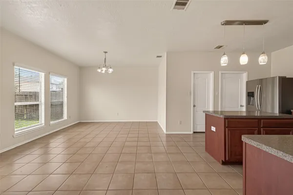 a kitchen with stainless steel appliances granite countertop a sink refrigerator and microwave