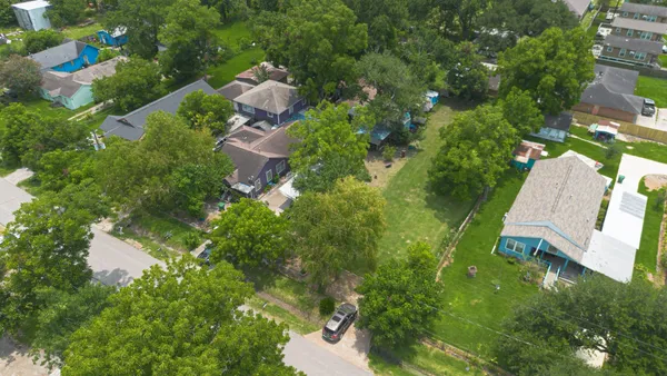 an aerial view of residential houses with outdoor space and street view