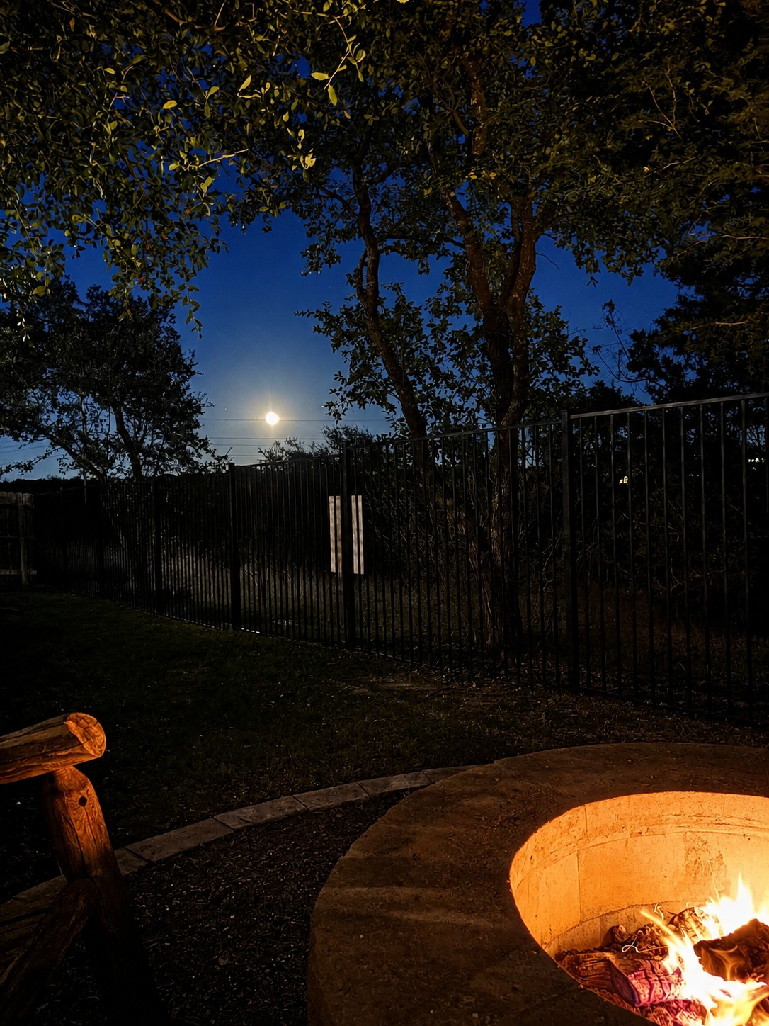 1908 Woolsey Way Leander, TX 78641 - Photo 26 of 36 Gather around this inviting fire pit under the moon light, perfect for cozy evenings outdoors.