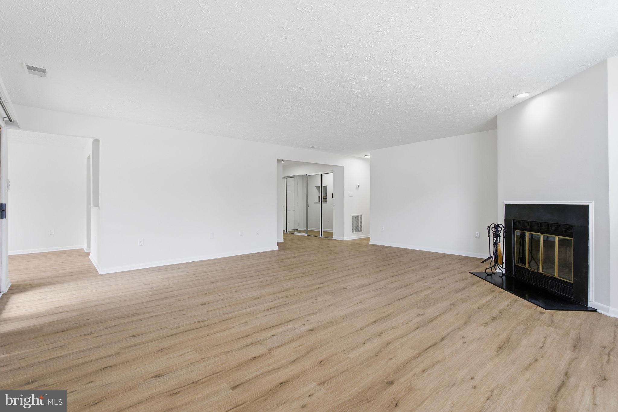 2201 Woodbox Lane, Unit 2201A Baltimore, MD 21209 - Photo 11 of 21 a big room with wooden floor and entryway