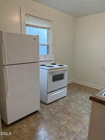 a kitchen with a stove top oven and sink
