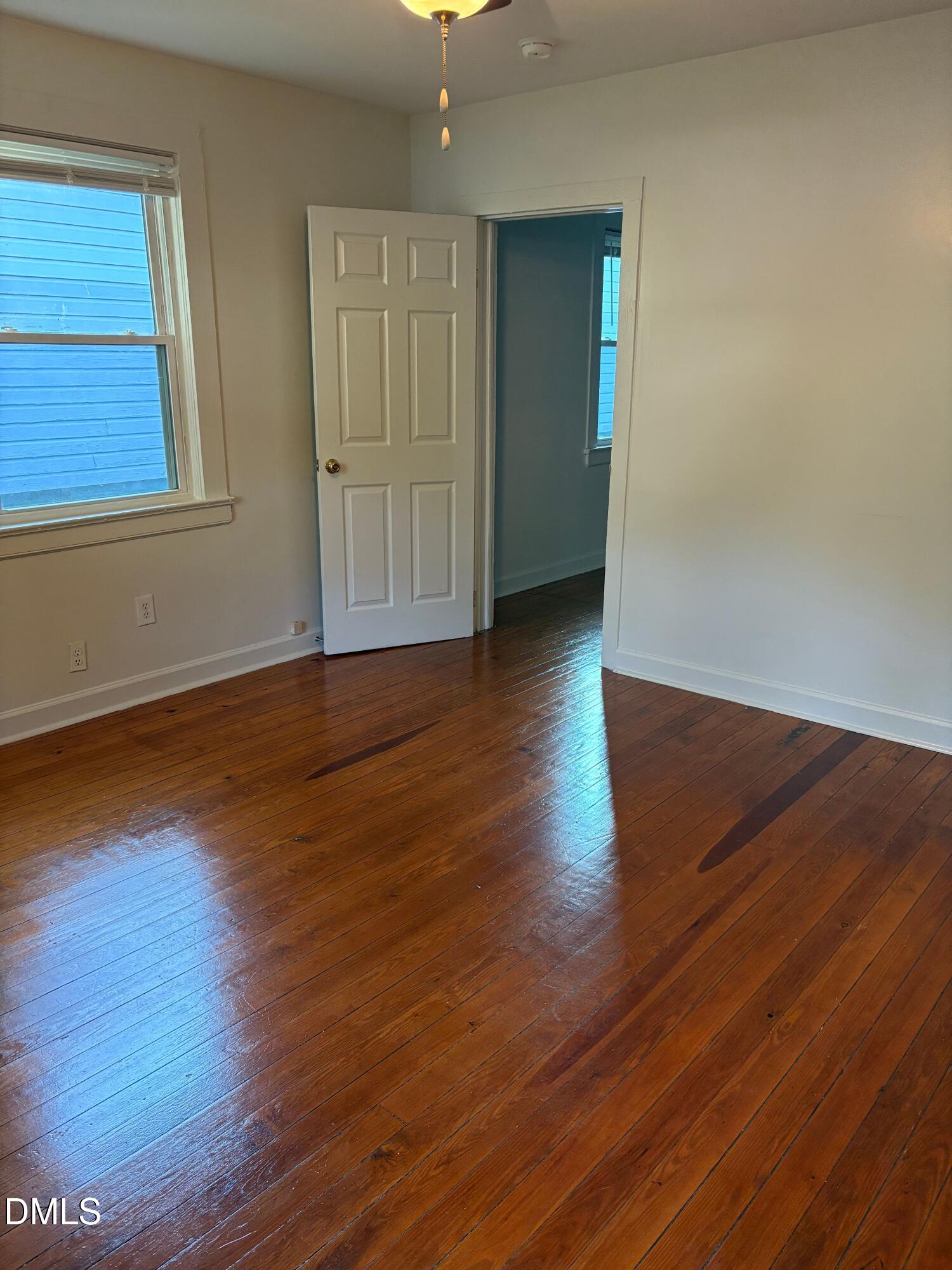 1020 Sedgefield Street Durham, NC 27705 - Photo 2 of 21 an empty room with wooden floor and windows