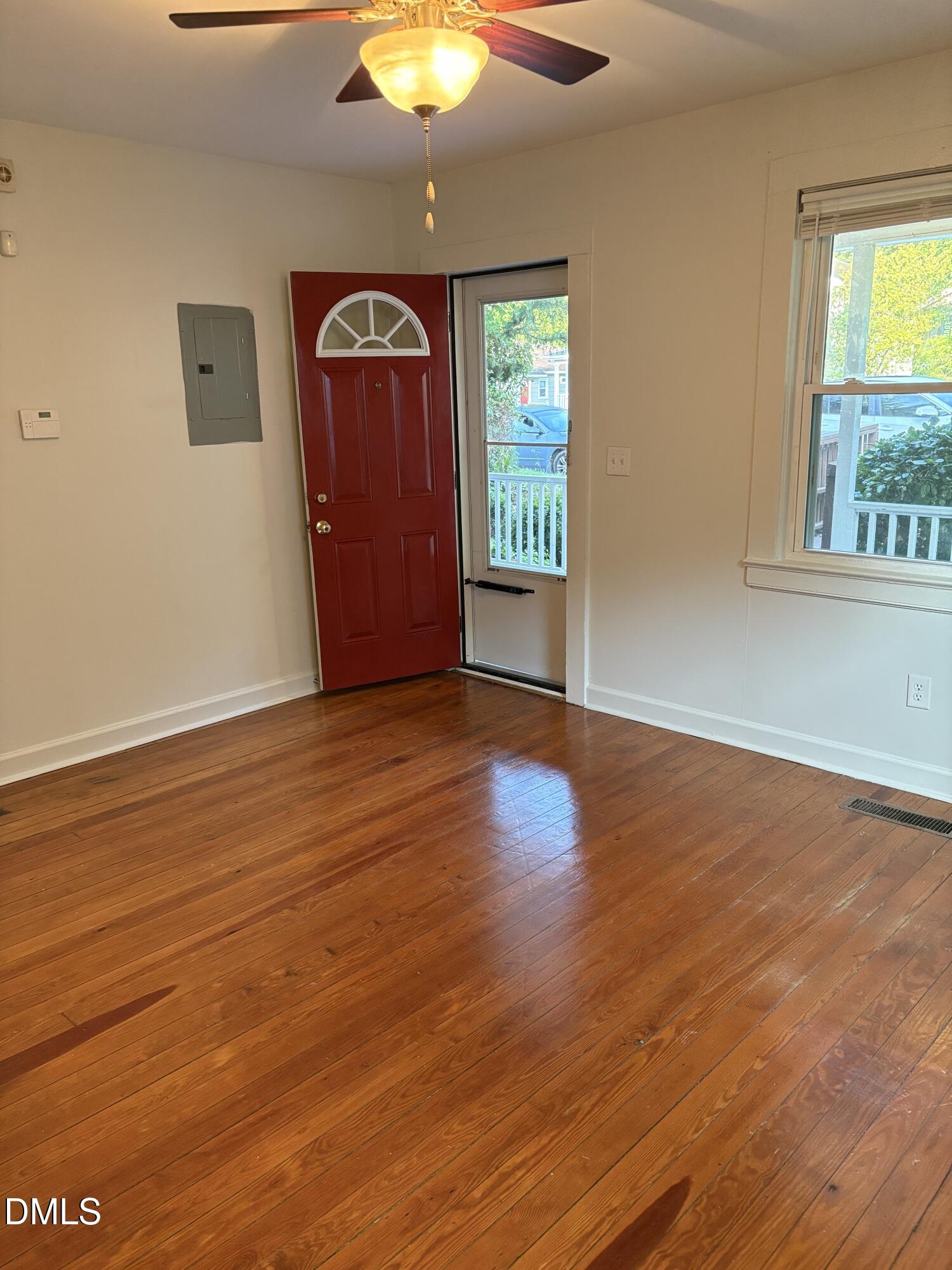 1020 Sedgefield Street Durham, NC 27705 - Photo 3 of 21 wooden floor in an empty room with a window