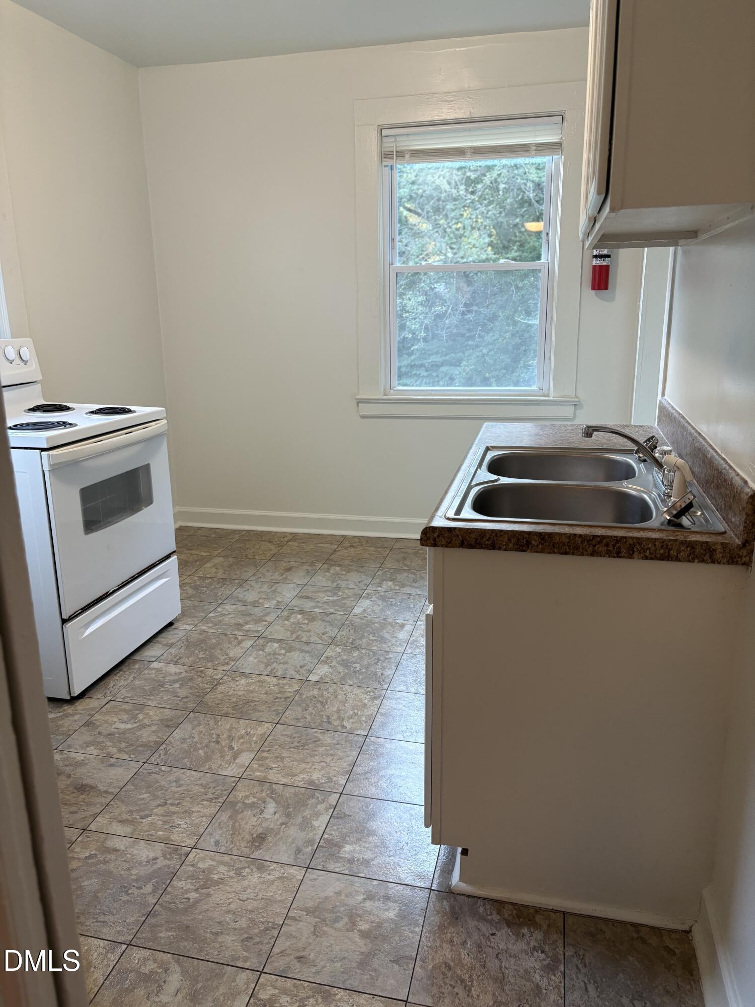 1020 Sedgefield Street Durham, NC 27705 - Photo 8 of 21 a kitchen with a stove top oven and sink