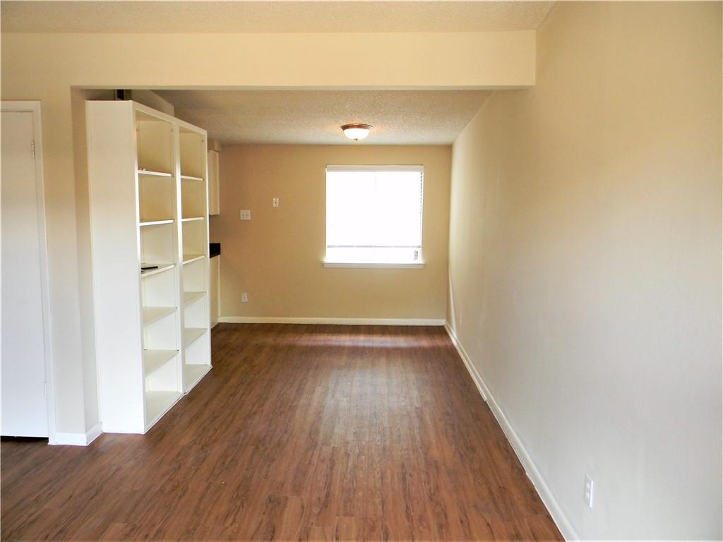2408 Longview Street, Unit 210 Austin, TX 78705 - Photo 1 of 8 an empty room with wooden floor and windows