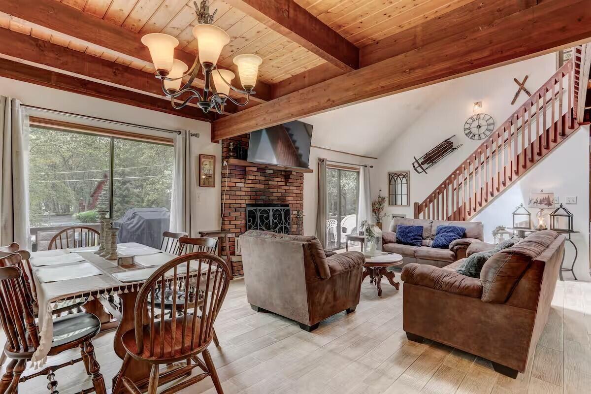 2255 Scarborough Way Bushkill, PA 18324 - Photo 5 of 24 a living room with furniture a fireplace and a chandelier