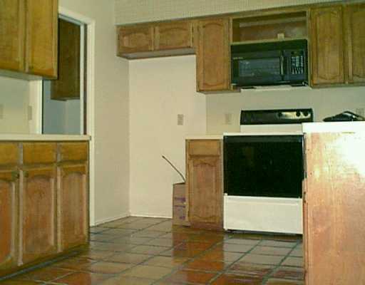 4418 Squaw Pass Court Corpus Christi, TX 78413 - Photo 3 of 8 a kitchen with stainless steel appliances a stove and cabinets