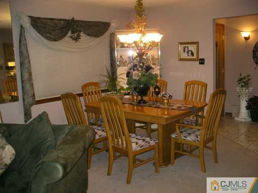 354 Old Post Road Edison, NJ 08817 - Photo 3 of 8 a view of a dining room with furniture and chandelier