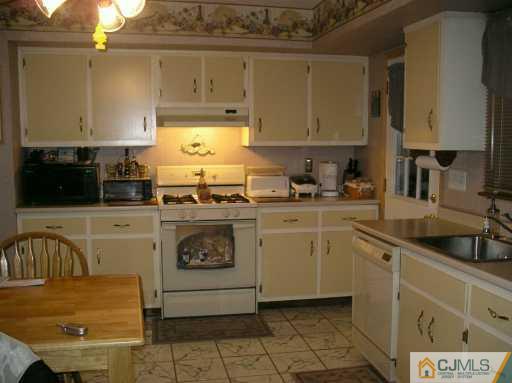 354 Old Post Road Edison, NJ 08817 - Photo 4 of 8 a kitchen with a sink a stove and cabinets