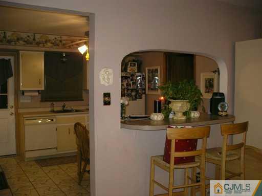 354 Old Post Road Edison, NJ 08817 - Photo 5 of 8 a view of kitchen with kitchen island dining table and chairs