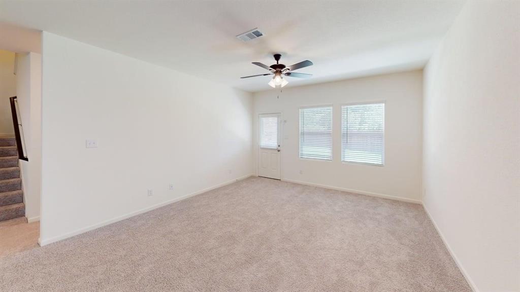 4529 Winecup Road Melissa, TX 75454 - Photo 7 of 29 Spacious room featuring neutral carpeting, light-colored walls, and a ceiling fan with integrated lighting