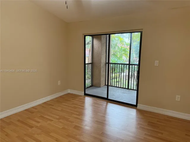 a view of a room with wooden floor and sliding window
