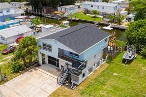 6728 Sea Ranch Drive Hudson, FL 34667 - Photo 2 of 69 an aerial view of a house with swimming pool and large trees