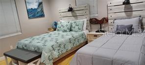 6728 Sea Ranch Drive Hudson, FL 34667 - Photo 22 of 69 a bedroom with a bed and a potted plant on the dresser