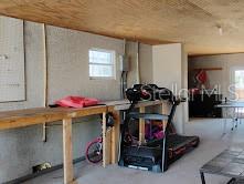 6728 Sea Ranch Drive Hudson, FL 34667 - Photo 48 of 69 a bedroom with a bed and a chandelier