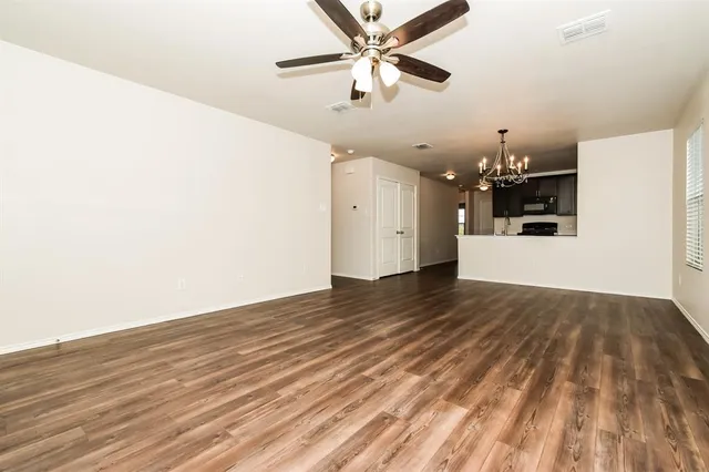 a view of a kitchen with a dishwasher and wooden floor