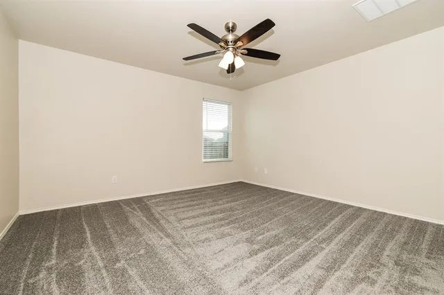 an empty room with closet and windows