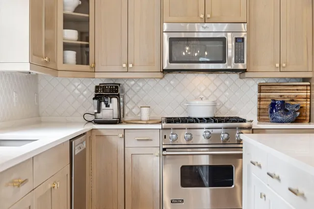 a stove top oven sitting inside of a kitchen