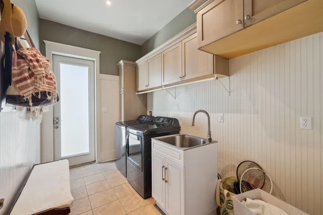 a kitchen with stainless steel appliances granite countertop a sink and a refrigerator