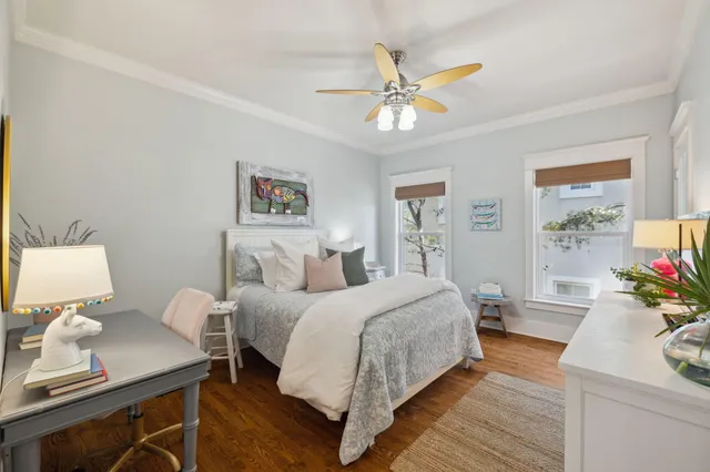 a bedroom with a bed and wooden floor