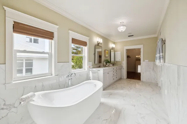 a spacious bathroom with a tub sink shower and mirror
