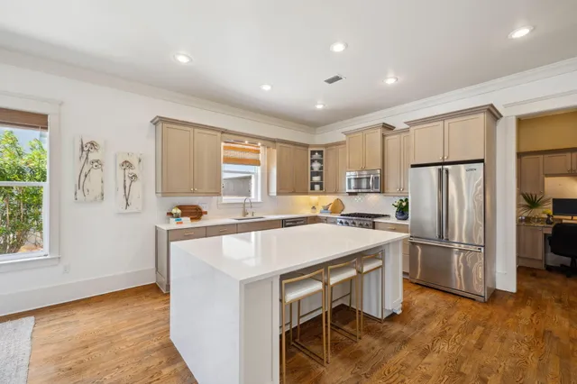 a kitchen with refrigerator cabinets and wooden floor