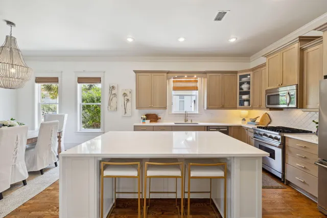 a kitchen with a table chairs sink and cabinets