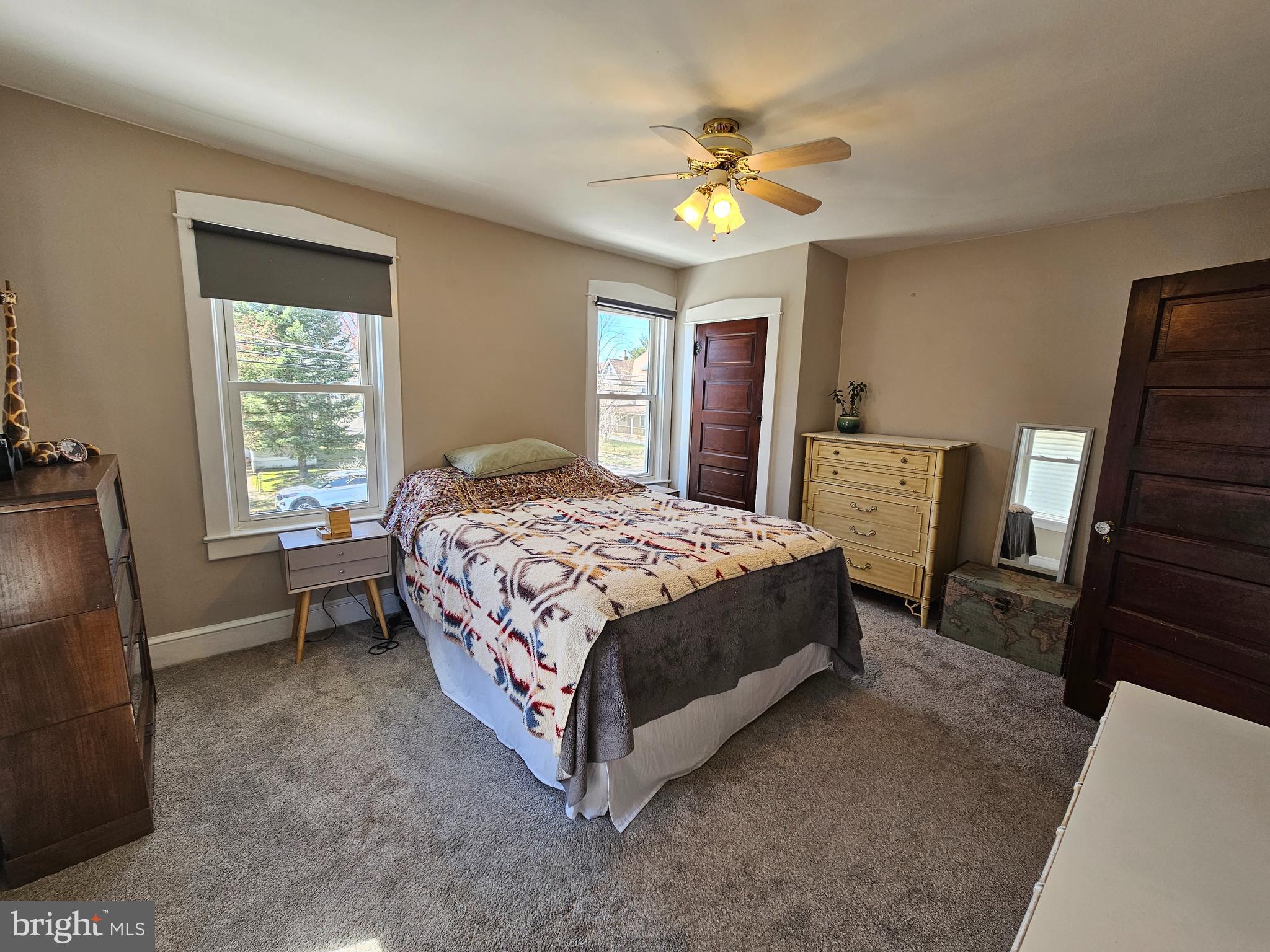 303 Delaware Avenue Riverside, NJ 08075 - Photo 17 of 30 a bedroom with a bed and a chandelier