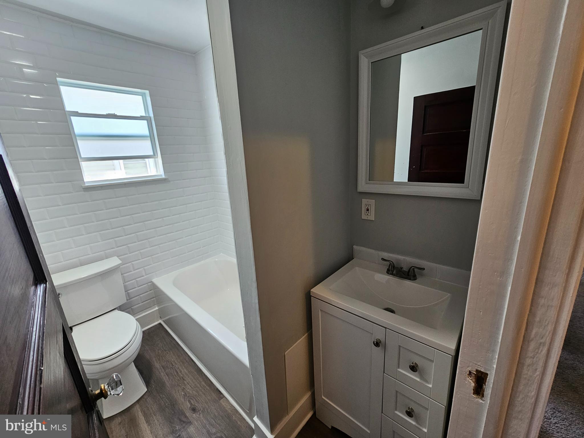 303 Delaware Avenue Riverside, NJ 08075 - Photo 26 of 30 a bathroom with a toilet sink and vanity