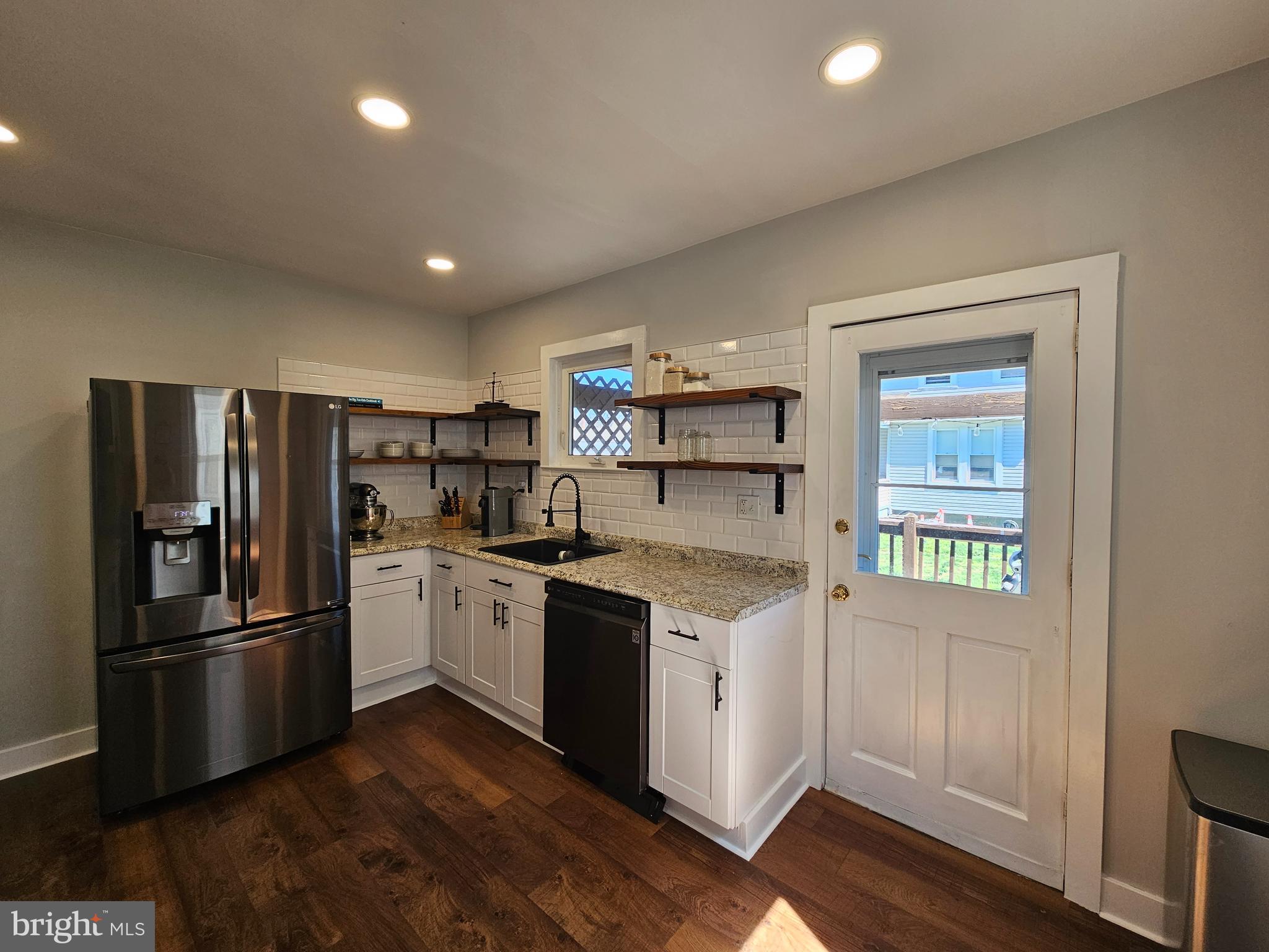 303 Delaware Avenue Riverside, NJ 08075 - Photo 7 of 30 a kitchen with granite countertop stainless steel appliances and wooden cabinets