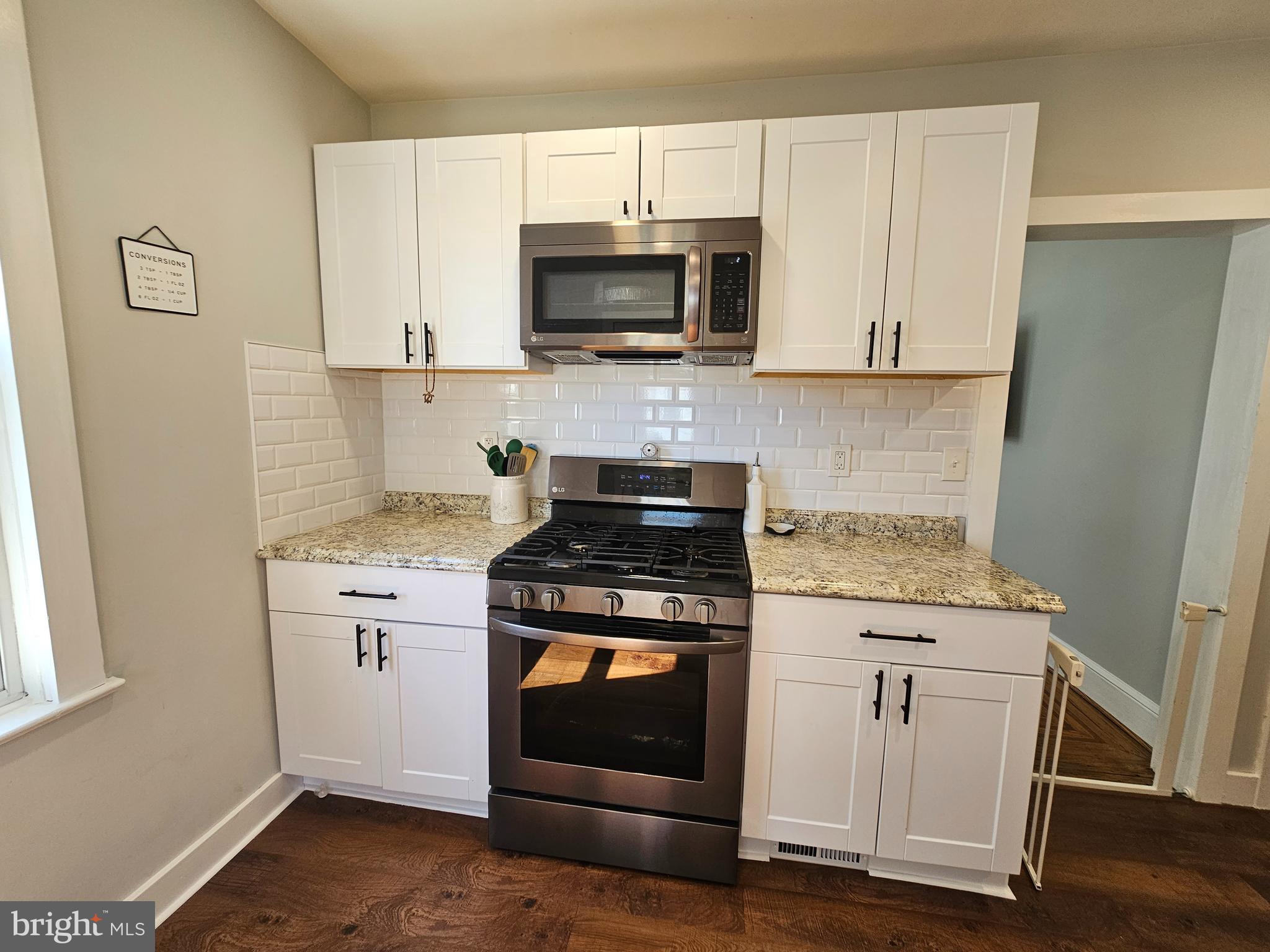 303 Delaware Avenue Riverside, NJ 08075 - Photo 10 of 30 a kitchen with granite countertop white cabinets and stainless steel appliances