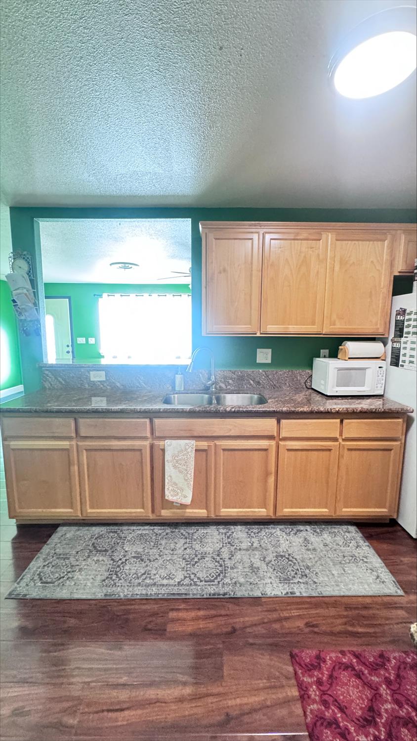 410 Sage Street Gridley, CA 95948 - Photo 12 of 43 a kitchen with granite countertop wooden cabinets and a granite counter top