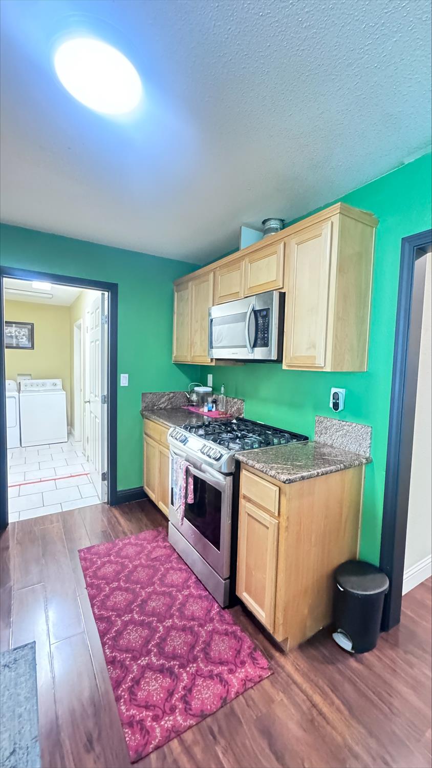410 Sage Street Gridley, CA 95948 - Photo 14 of 43 a kitchen with stainless steel appliances granite countertop a stove a sink and a microwave