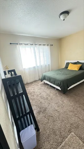 a bedroom with a bed and lamp